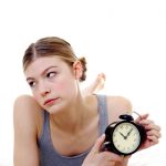 woman waiting with clock